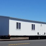 LaserQuik trucks transporting mobile offices